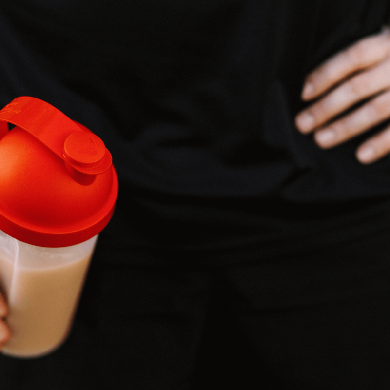 male holding a shaker bottle with whey protein